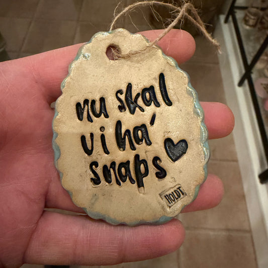 Ophæng, påskeæg med tekst: nu skal vi ha’ snaps, lys blå